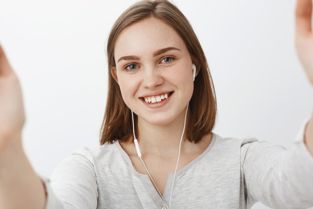 friendly-looking-cute-happy-young-woman-taking-selfie